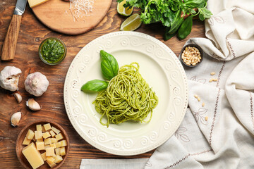 Plate with tasty pesto pasta on table