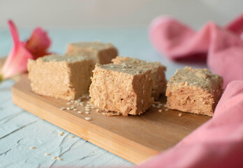 Sesame halva on blue background. Traditional Middle Eastern sweets. Jewish, Turkish, Arabic national dessert. Turkish delight.A place to copy
