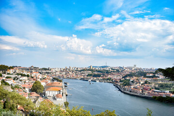 Fototapeta na wymiar City of Porto around Duero river, Portugal. Sunny cloudy day