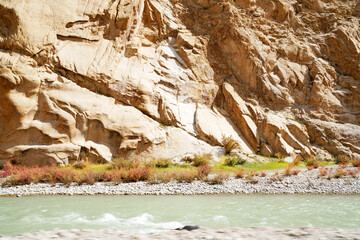 Nature scene - Red and Yellow leaves tree of fall foliage in begin autumn season with blue river canal at Leh Ladakh , Jammu and Kashmir , India