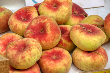 Close up of flat peach also known as the donut peach or Saturn peach
