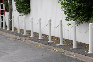 white steel bollards with white chain.
