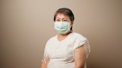Happy senior woman wearing mask after vaccinated, Ideas for senior citizen getting fully...