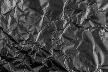 Black crushed damaged aluminum metal foil texture