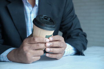 businessman hand holding take away paper cup white sited 