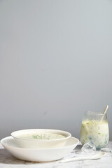 Summer refreshing cold yogurt soup, healthy meal with fresh raw vegetables and dairy ingredients