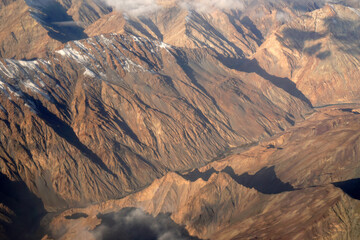 Blurred Nature scene - Aerial top view of Snow Mountain of himalaya mountains on sunny day summer season at Leh Ladakh , Jammu and Kashmir , India  - Beautiful brown  nature Texture Background  - obrazy, fototapety, plakaty