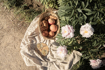 Romantic picnic on the lawn with peonies.