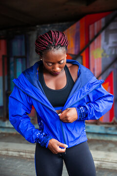 Sporty woman zipping jacket