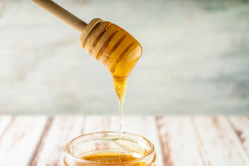 Honey stick dripping pure organic honey from bees.
