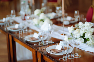 Beautiful table setting for a party, wedding reception or other festive event. Banquet setting, glasses, plates.