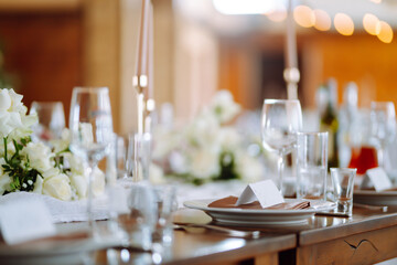 Beautiful table setting for a party, wedding reception or other festive event. Banquet setting, glasses, plates.