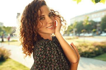 Portraits of a charming red-haired girl with freckles and a pretty face. The girl poses for the...