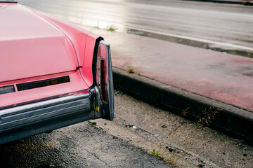Back focus detail of a classic pink car