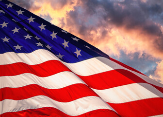 Obraz na płótnie Canvas American flag waving in the wind at sunset.