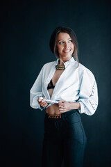 Beautiful young woman in white shirt smiles