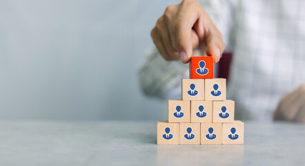 Recruiter complete team represented by wooden cube by one leader person (CEO) and icon,human resources, corporate hierarchy concept.