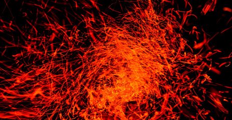 Fototapeta na wymiar Sparks from fire on a black