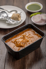 chicken butter masala served and chapati in packing food