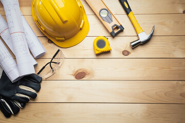 Work safety. Standard Construction site protective equipment on  top view wooden background, flat lay, copy space,safety first concepts.