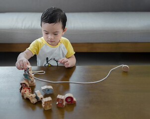 Asian little boy playing with toys, infant early childhood education, child development concept.