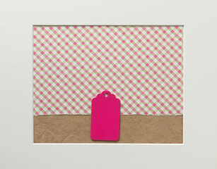 old school or retro chalkboard tag arranged on a patterned paper background, with a mat board...