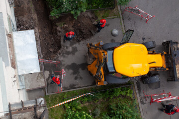 Workers digging and pulling the fiber optic cable