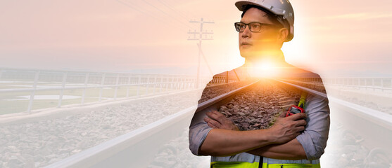 Double exposer engineer railway wearing safety uniform and helmet hardhat work with a long railway and sunsky background.