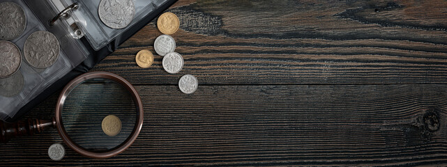 Numismatics. Old collectible coins on a wooden table.