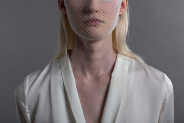 Closeup portrait of white caucasian albino blond woman fashion model wearing quarantine medical...