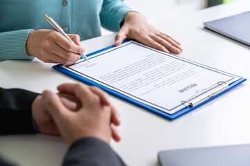 Fototapeta premium HR managers are interviewing job applicants who fill out their resumes on the job application form in order to consider accepting a job as a company. Young woman doing a job interview