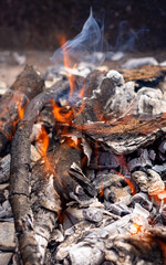 Bonfire. Smoldering firewood close-up. Cooking food in the field.