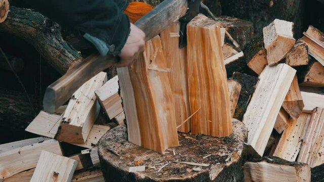 Big old wooden ax chops down tree trunks on the background of a cut log