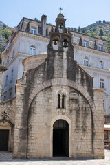 Old town of Kotor Montenegro on the background of mountains and blue sky. The bright beautiful landscape of  against the background of mountains in the summer on a clear day