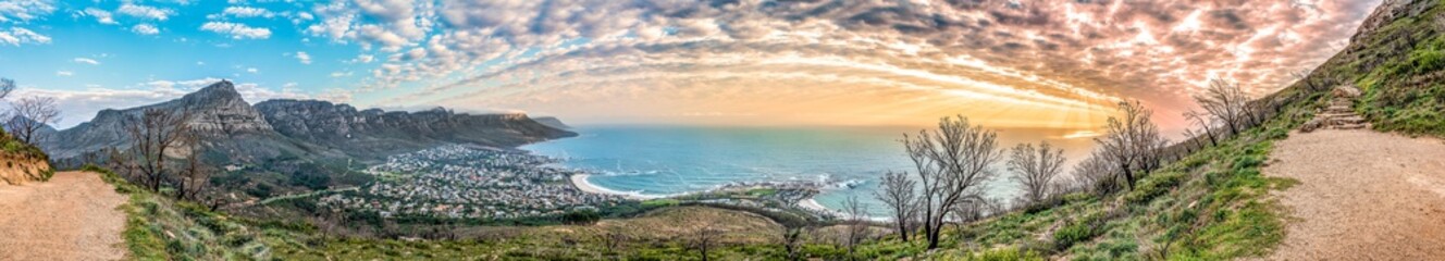 Breathtaking sunset panorama of the iconic Table Mountain and the Twelve Apostles range, Cape Town South Africa. A unique and scenic wide-angle perspective taken from Lion's Head mountain