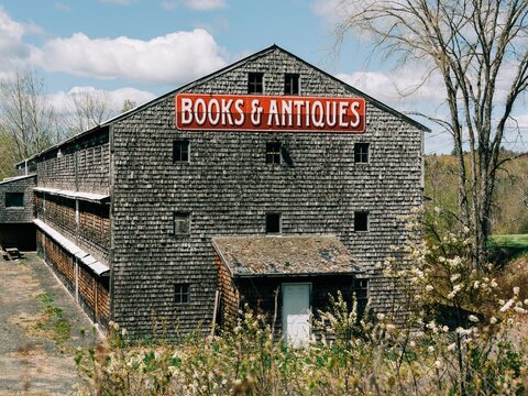 Old barn with Books & Antiques sign in Ellsworth, Maine