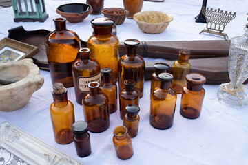 Brown glass medicine bottles for sale at a stall in the streets of Tongeren in Belgium, a weekly famous large antique market on Sundays