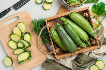 Preparation of zucchini. Ripe zucchini on a gray background. Top view.