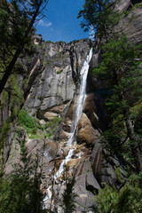 Fototapeta premium Waterfall and Mountains in Kadinggou Scenic Spot, Nyingchi, Tibet, China