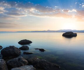 Fototapeta na wymiar quiet sea bay at the sunset, natural summer sea scene