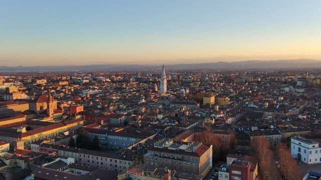 modena cityscape aerial shot at sunset drone flying backwards over city centre at dusk ,emilia romagna italy 4k