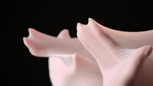 Female hands under nylon tights
