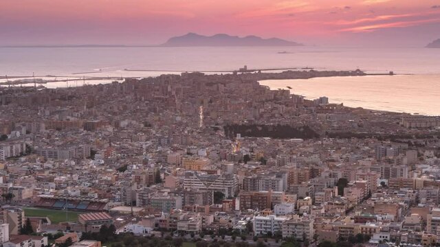trapani city aerial view time lapse from day to night,view of the sicilian town at sunset,sun sets over the sea 4k