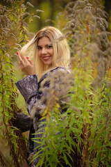 beautiful girl in autumn beautiful foliage in the forest in the tunnel