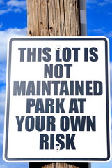 Parking lot sign displayed outdoors.