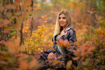 beautiful girl in autumn beautiful foliage in the forest in the tunnel