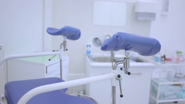 Blue gynecological chair in the women's health clinic. Close-up of an examination chair for pregnant women. The gynecologist's office is slow moving. Doctor's examination of pregnant women