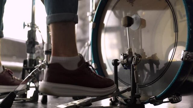 Close Up of Mans food kicking drum mechanism. drum pedal