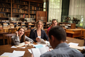 Students preparing exam and learning lessons in school library