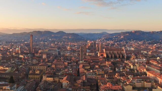bologna skyline aerial view drone flying sideways over historic city center,italian town cityscape at dawn shot at sunrise,emilia romagna italy 4k